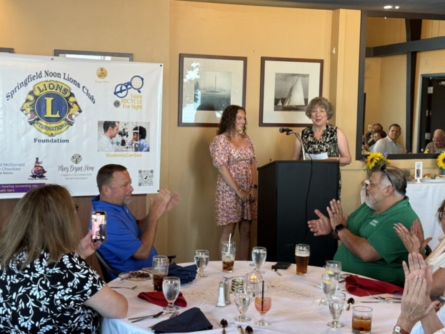 Gina and scholarship winner Payton Heise with proud mom and dad looking on