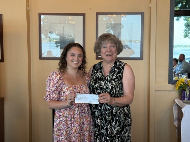 Payton receiving her $1,000 check