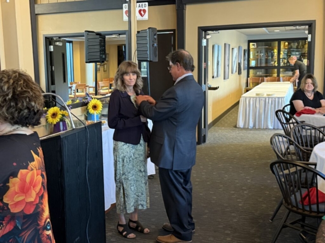 Craig pinning Lions Pin on Leann